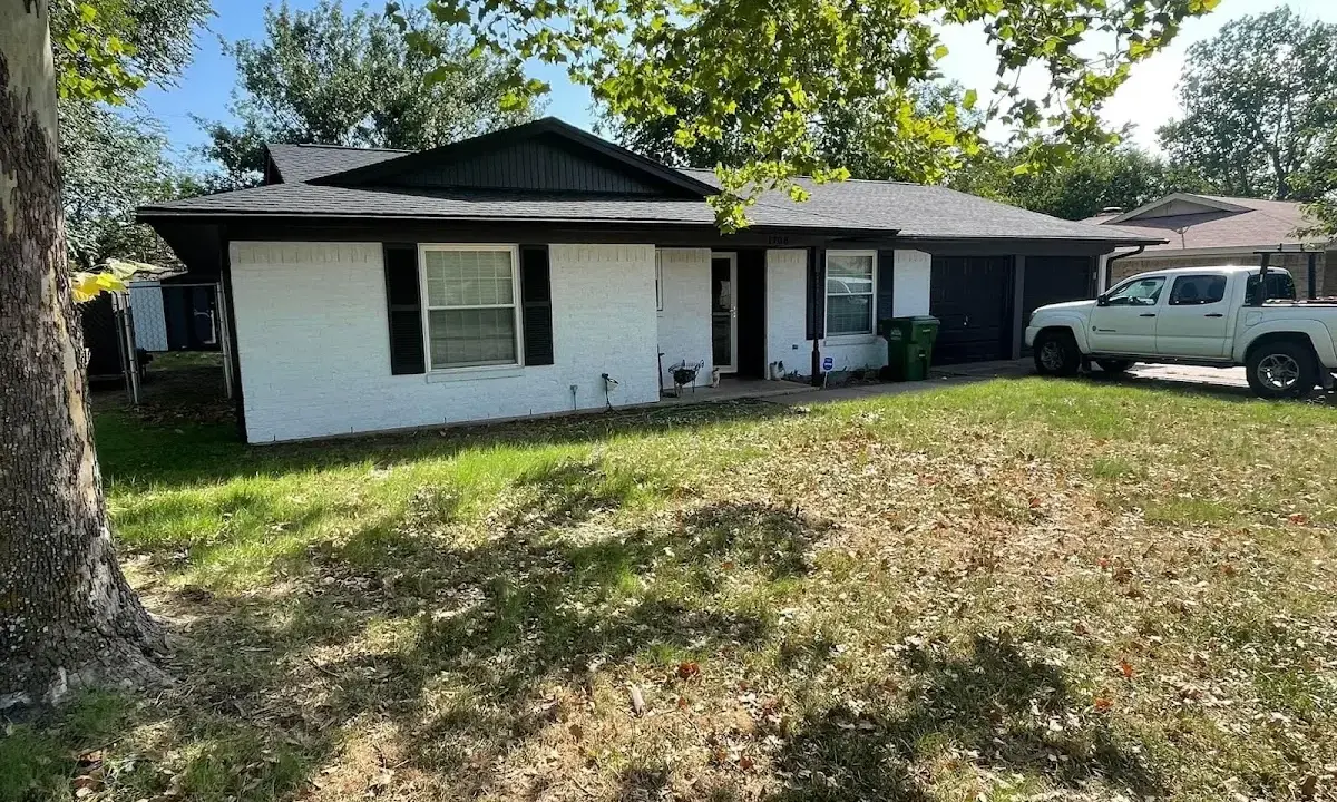 Professional roofing crew working on a residential roof in Gray